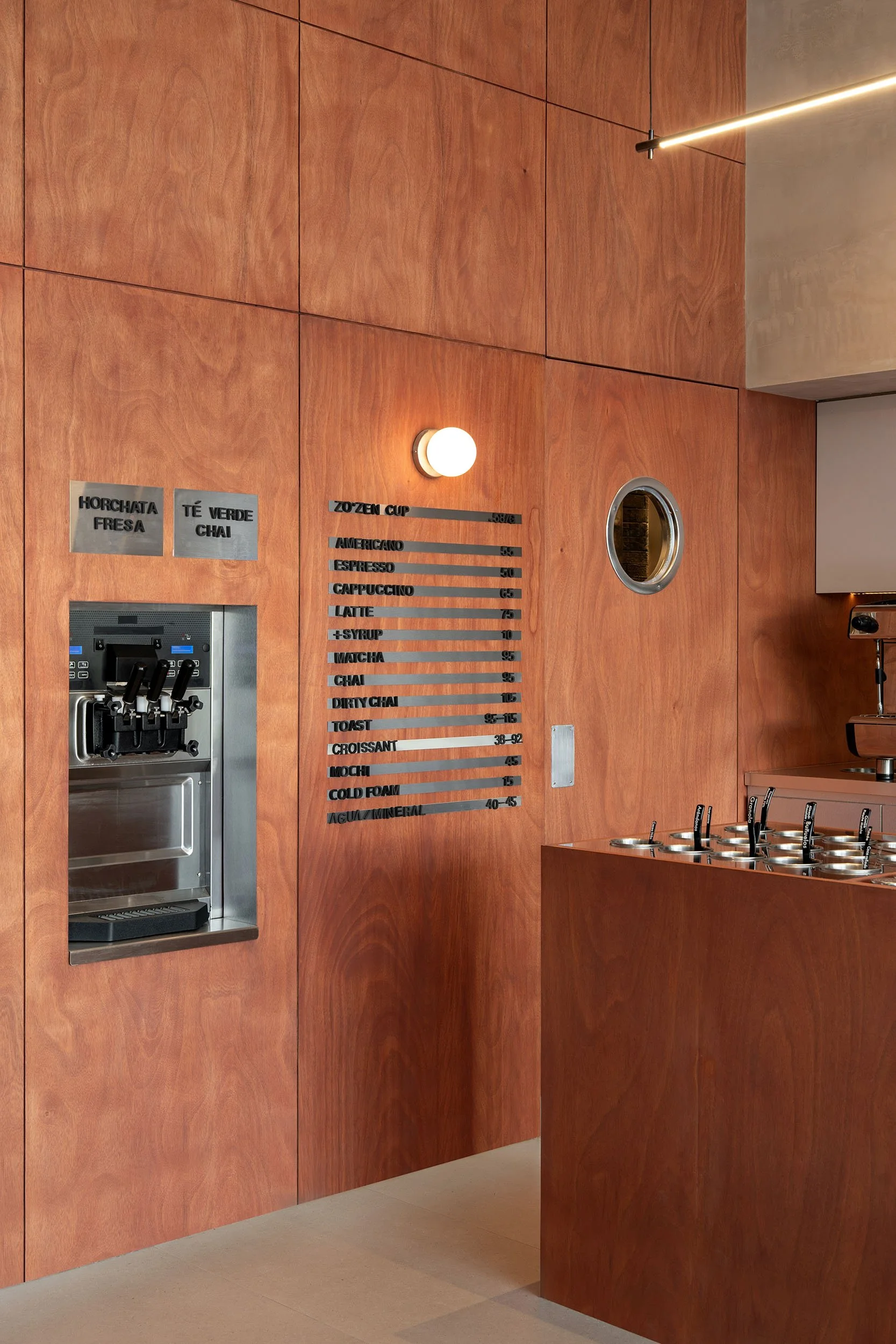 Custom-built topping counter with bespoke millwork inside Zo'Zen froyo shop in San Pedro Garza García, interior design by Mariel Lozano Studio, photo by Recording Architecture.