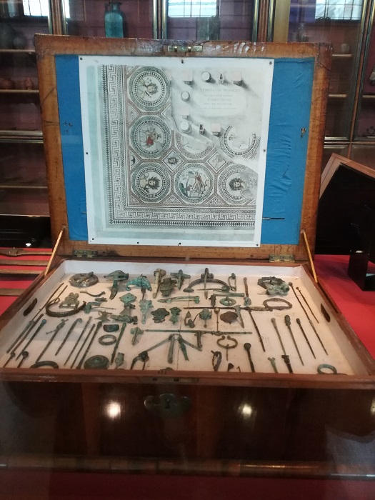 The William Allen box – “made in the late 17th century, a rare survival of an antiquary’s private collection. It belonged to William Allen (1808-1897), member of a prominent Quaker family. Allen had a passion for material from Roman Britain… The tray… is one of three in the box and contains mostly bronze brooches and hair pins”.
