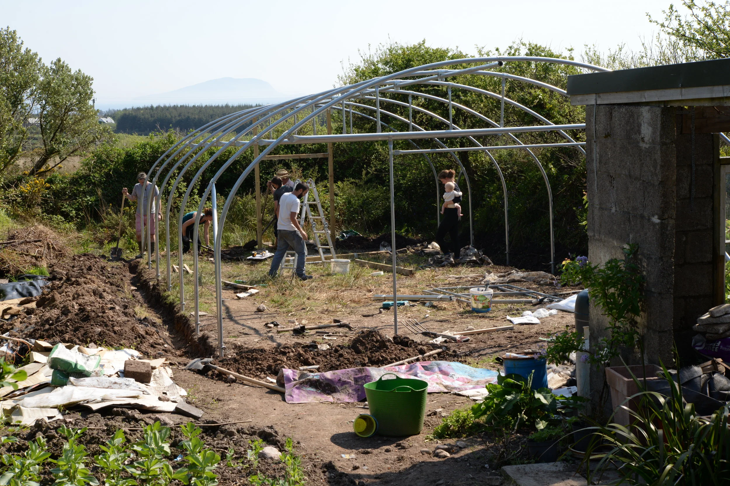 Assembling the door frames. Digging trenches along the border for anchoring the plastic