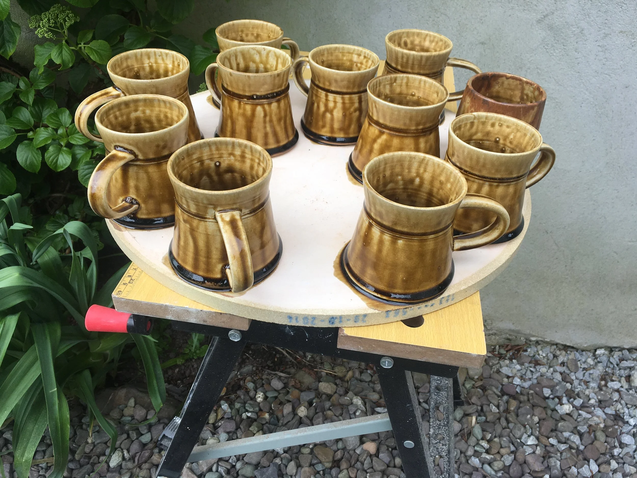 These mugs are held to shelf after this ash glaze ran to far in the firing process. 