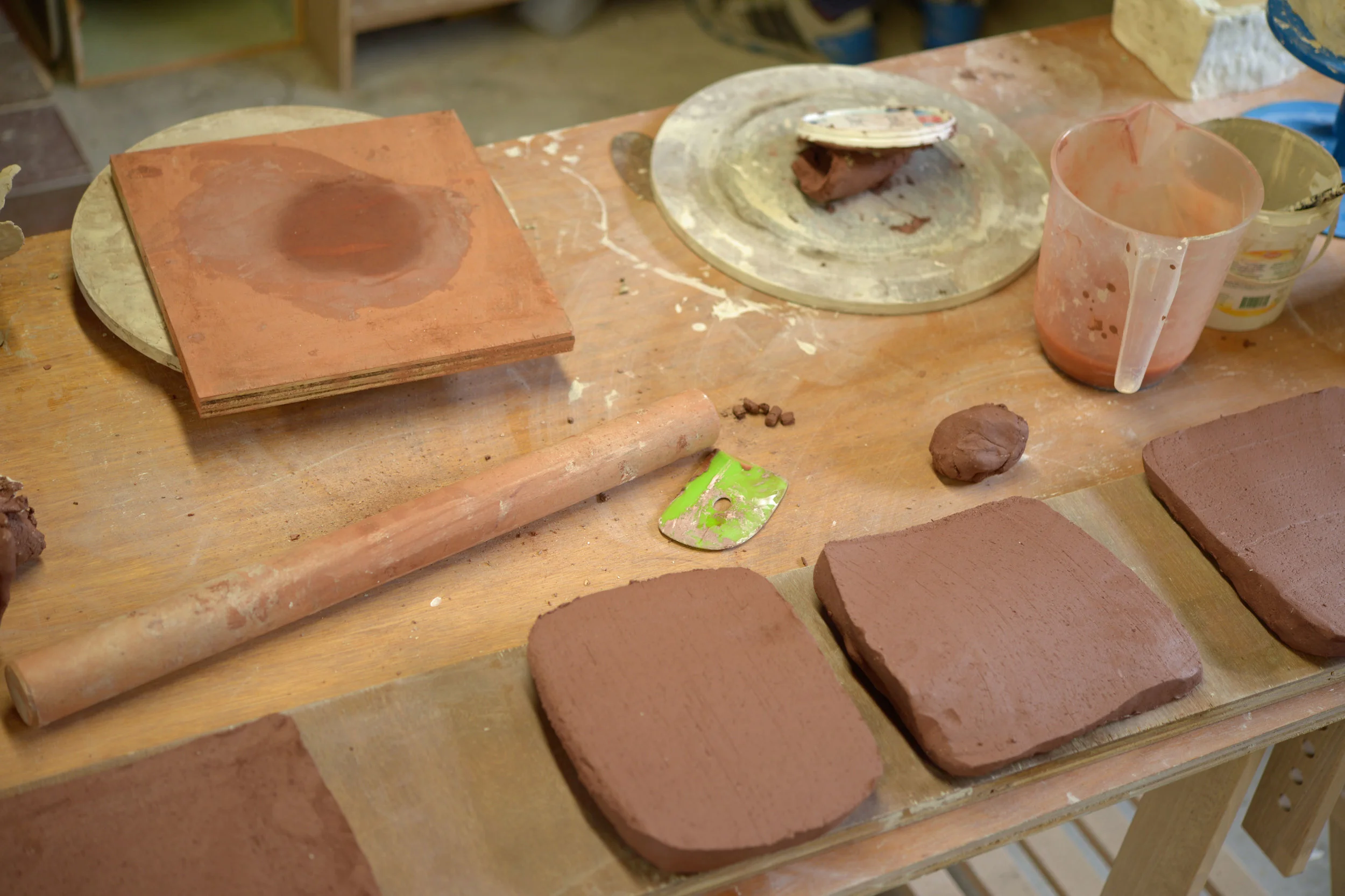 Firstly we roll out thick slabs of dark clay