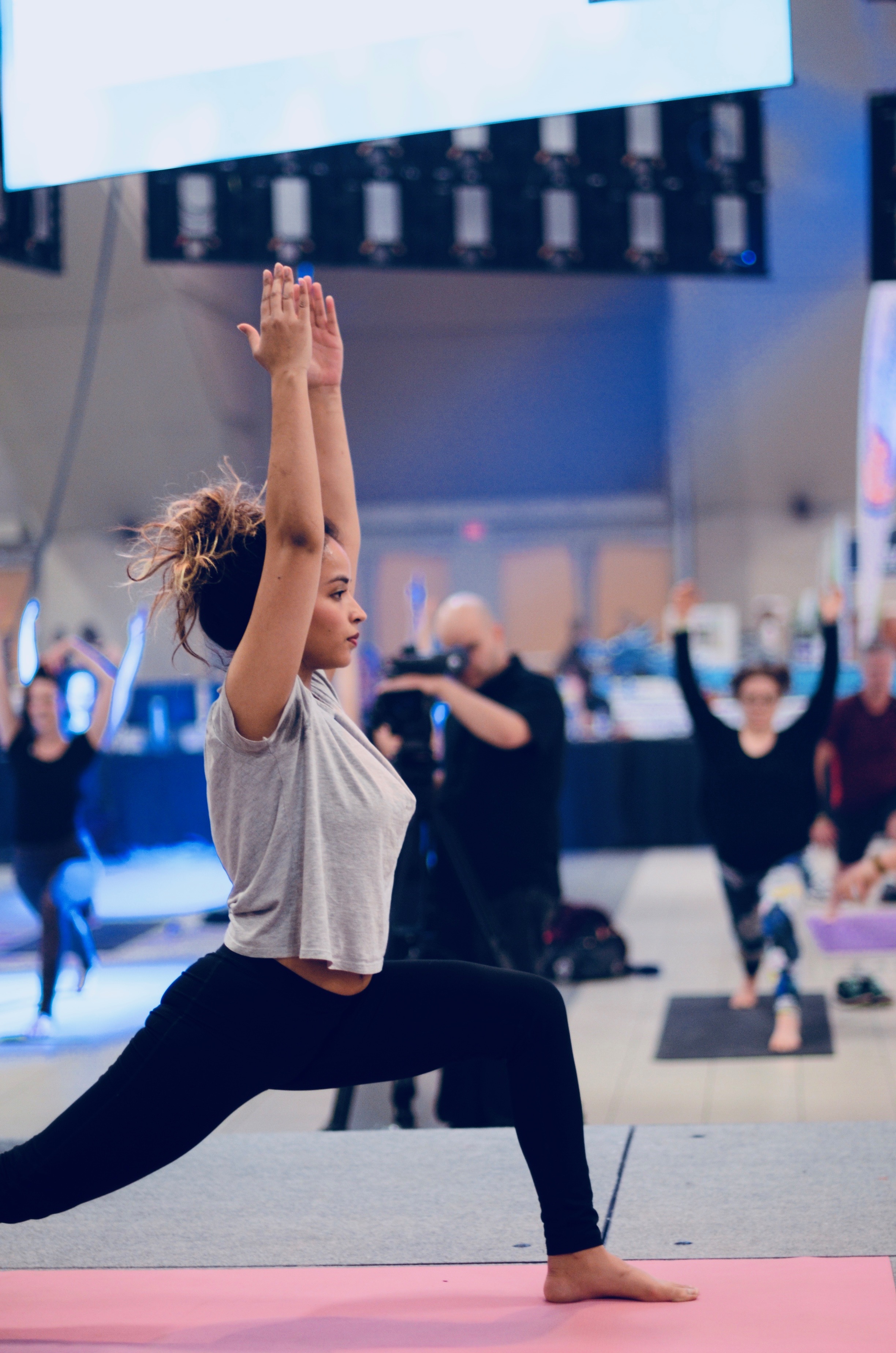 There's Yogalife North's Sarah on stage demonstrating for Emerald's Sunday class.