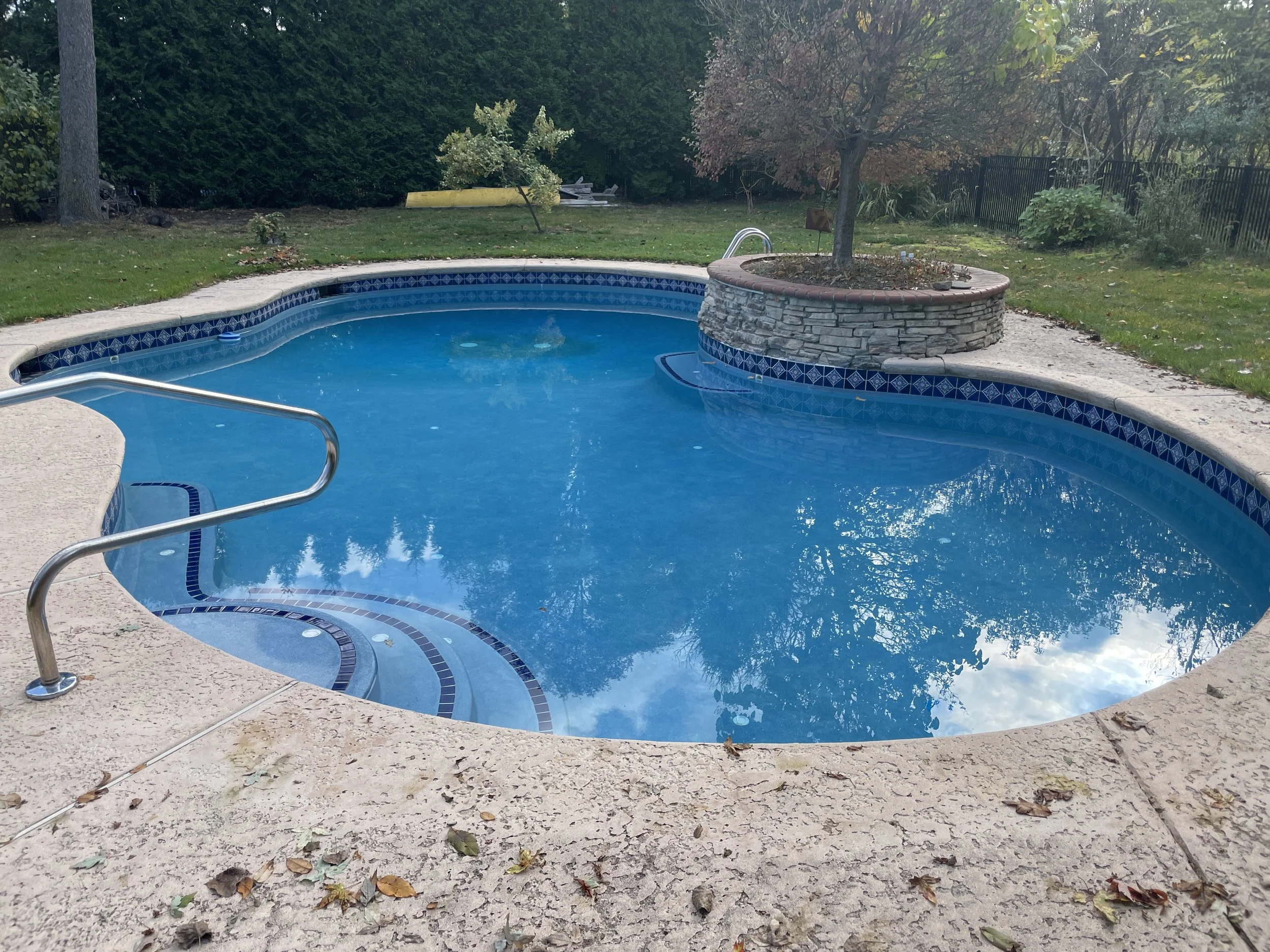 Professional pool water balancing and maintenance in Penfield, NY. The Handy Family team ensuring crystal clear water for a residential inground pool near Bridle Path.