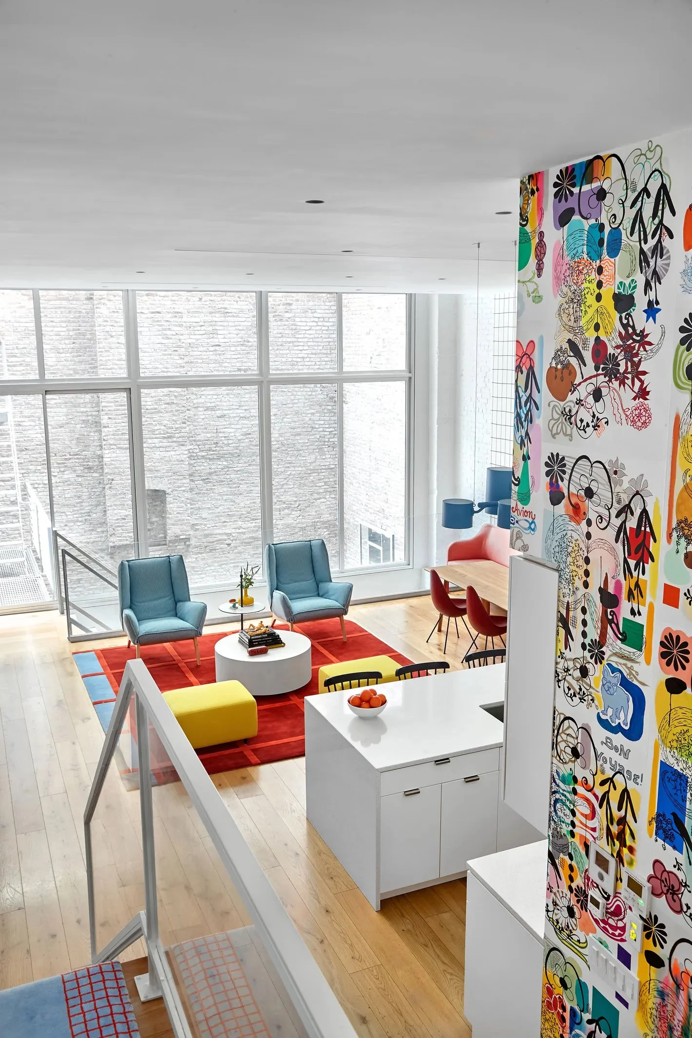 Modern interior living space with  floor-to-ceiling windows, colorful painted wall mural art French dot., mid century loft Tribeca interior space. Manhattan.