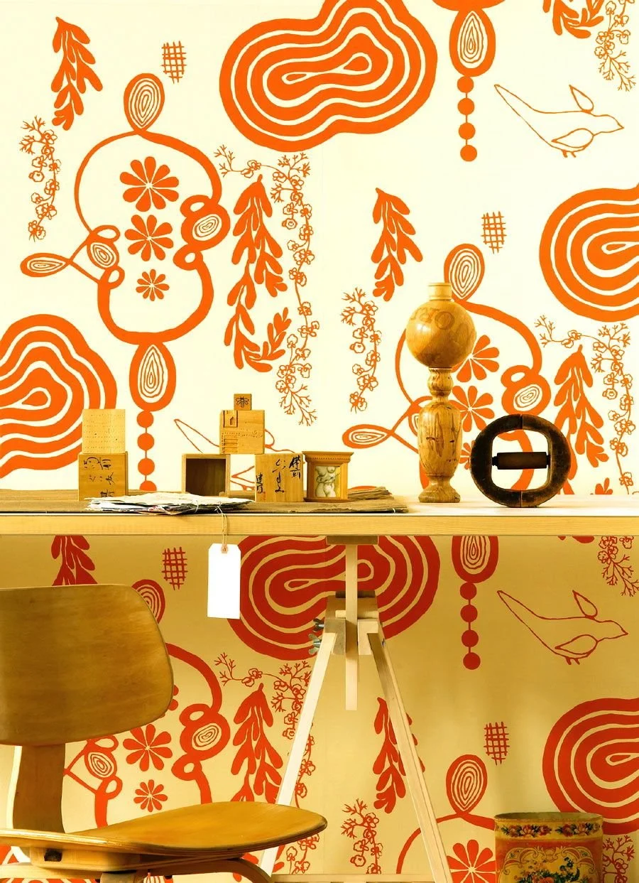 NAMA ROCOCO Sixty eight wallpaper in mellow orange.  mid century modern table and objets d'art.
