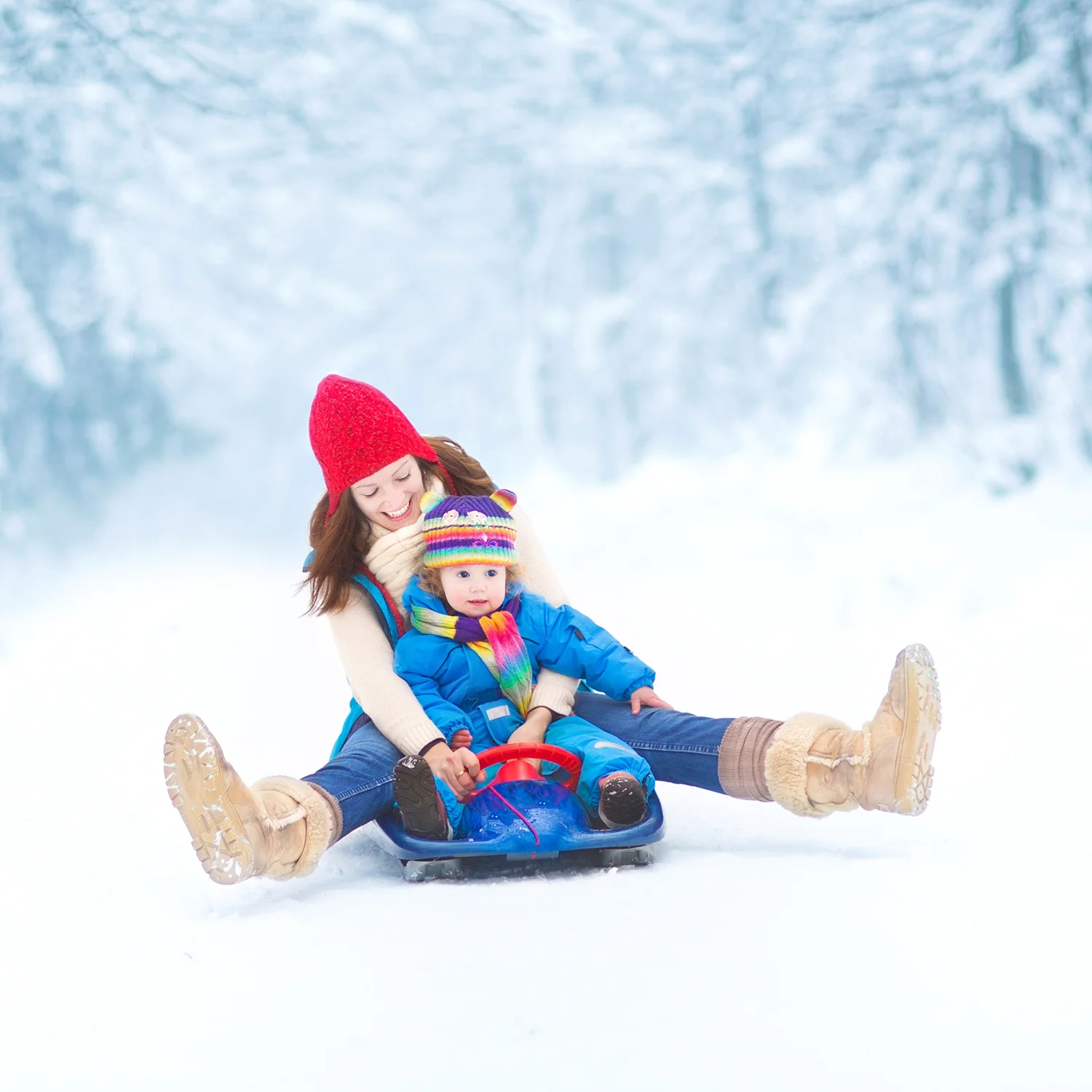 Mother-and-toddler-daughter-enjoying-sledge-ride-in-snowy-park-000038408102_Large.jpg