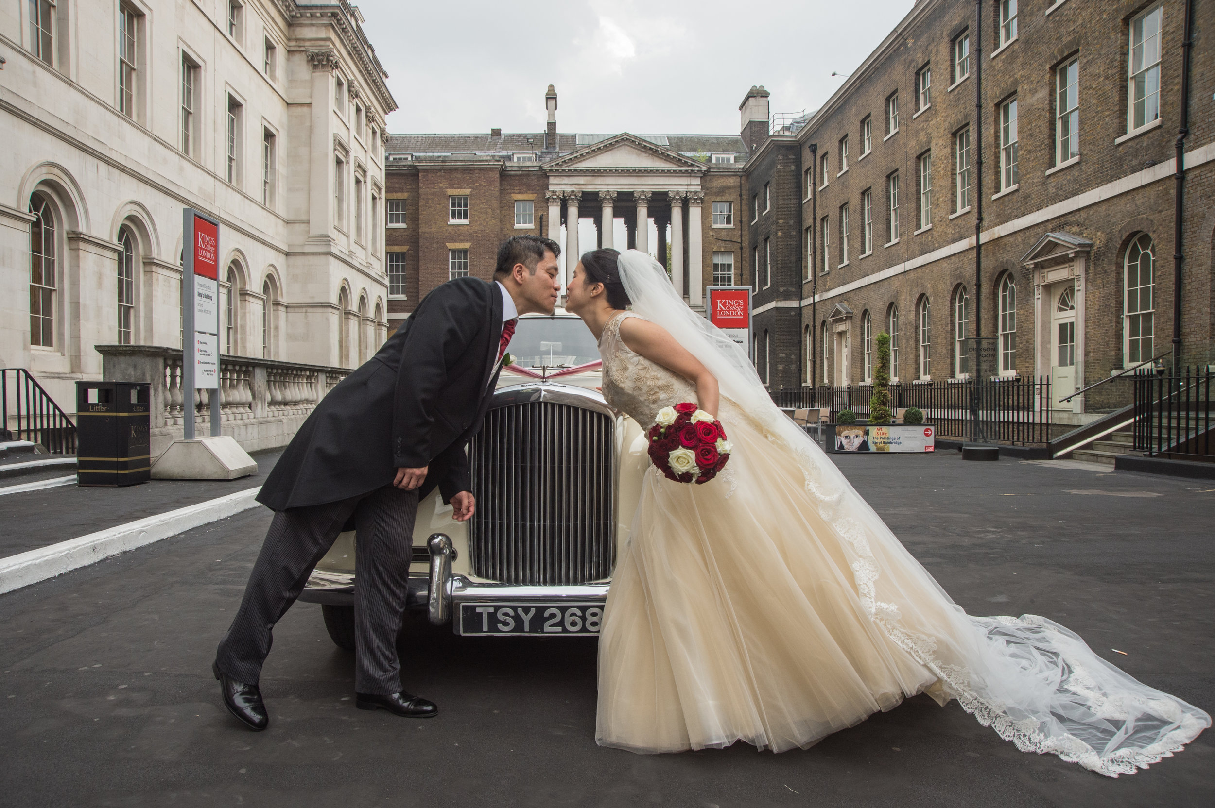 Bride and Groom with wedding car in the Courtyard of Kings College London
