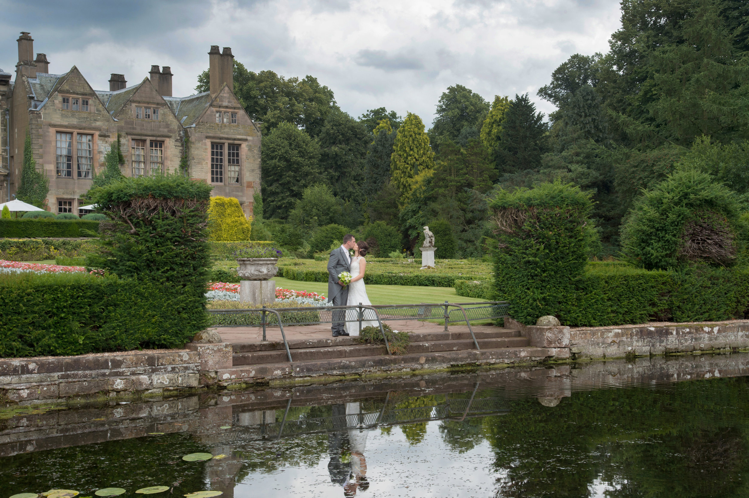 Bride and Groom by the lake Coombe Abbey Hotel Coventry Warwickshire