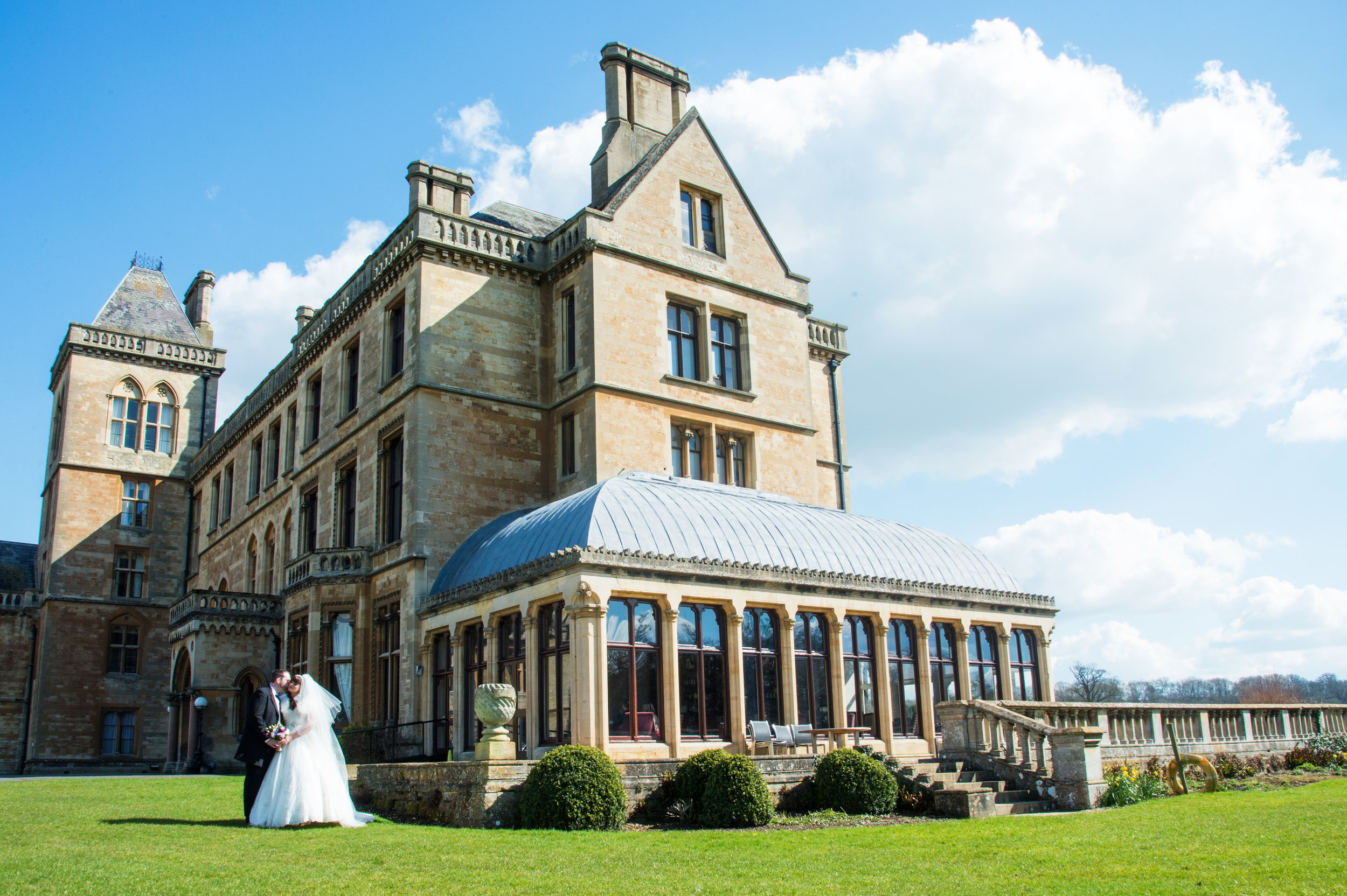 Bride and Groom in front of Walton Hall Hotel Warwickshire