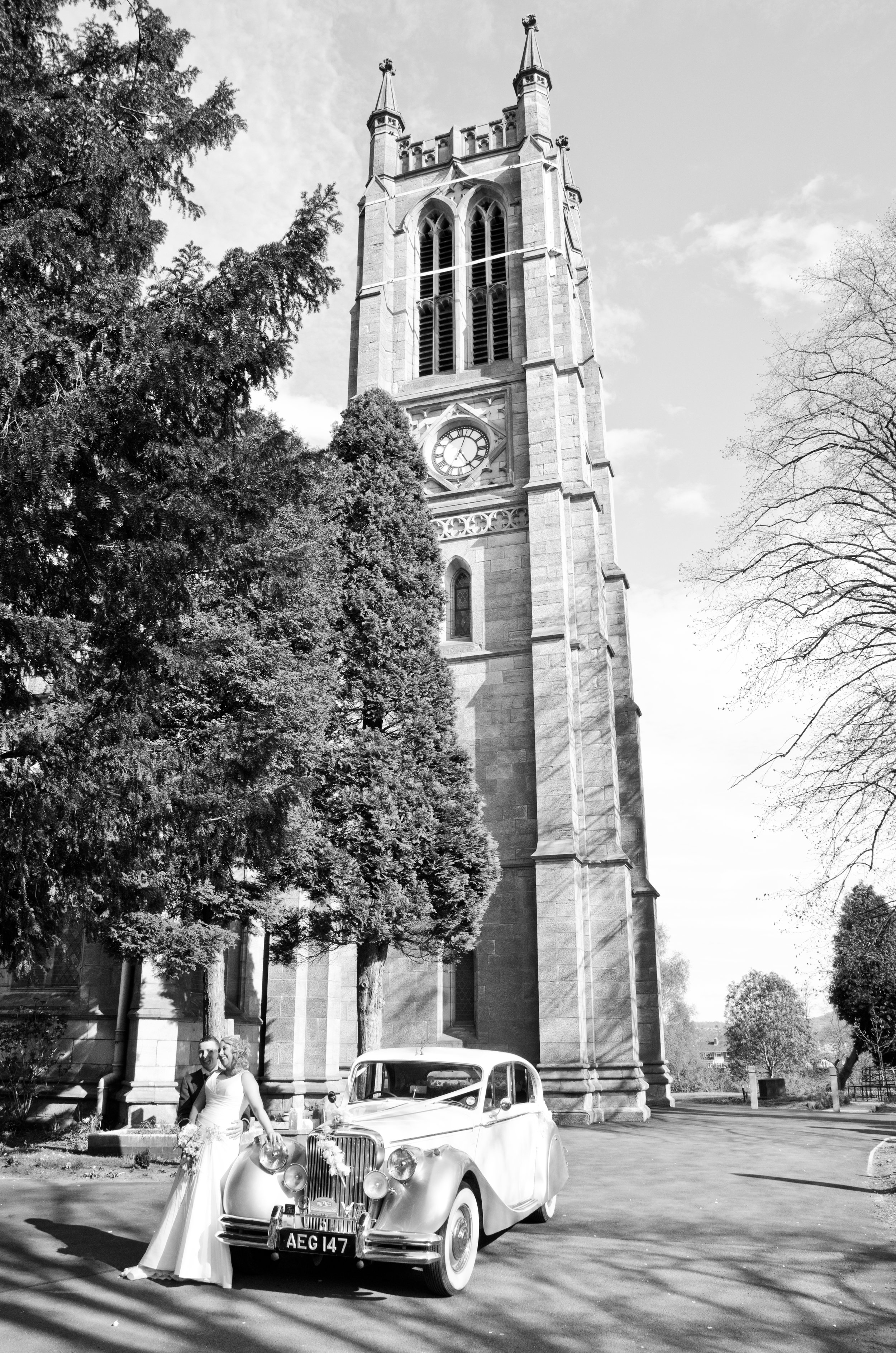 Bride and Groom by wedding car Holy Trinity Church Wordsley Stourbridge