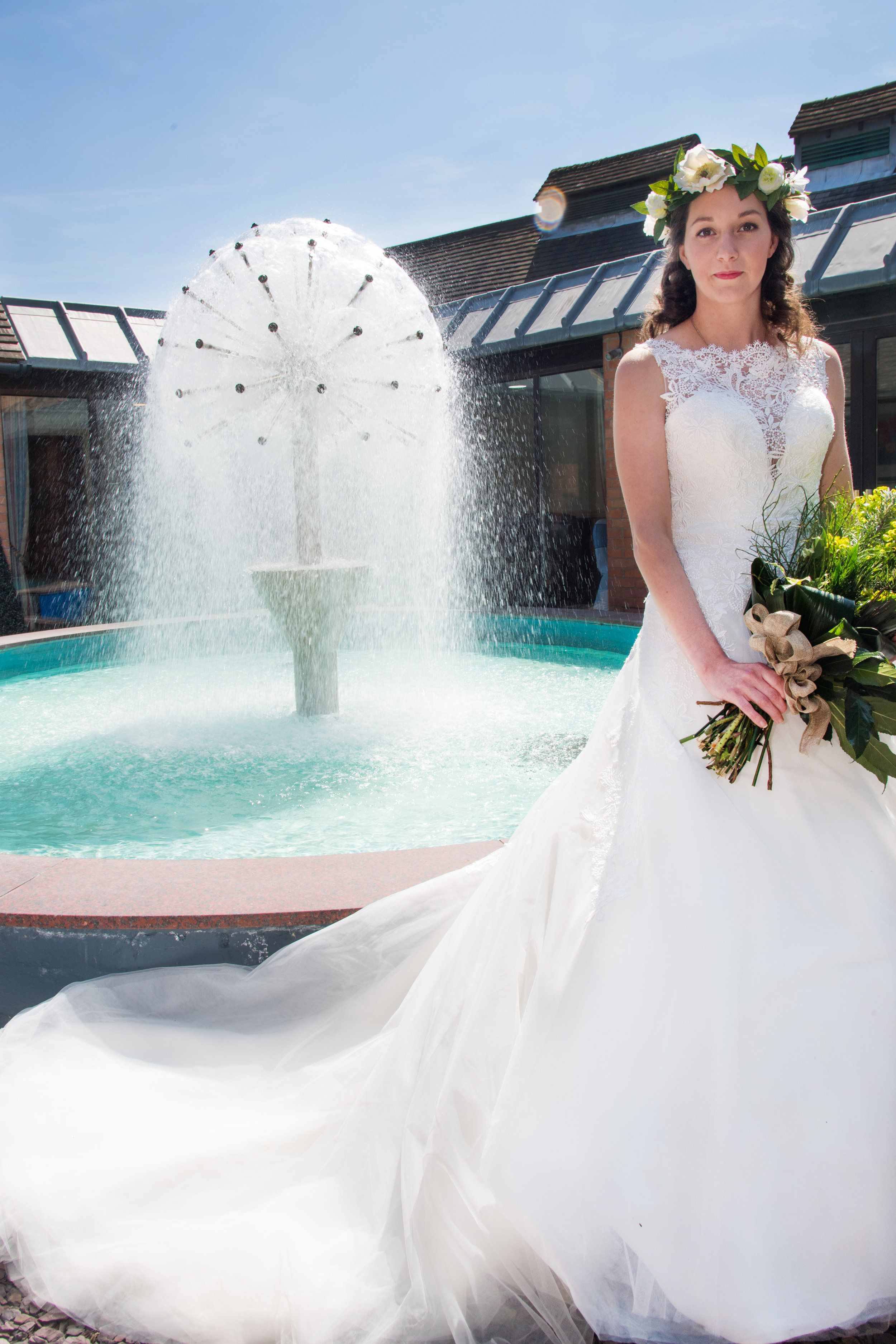 Bride in front of the fountain at Henley Golf and Country Club