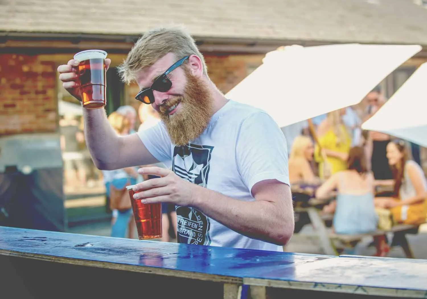 blackpit-opening-party-hipster-enjoying-a-pint-of-ale-and-saying-cheers.jpg