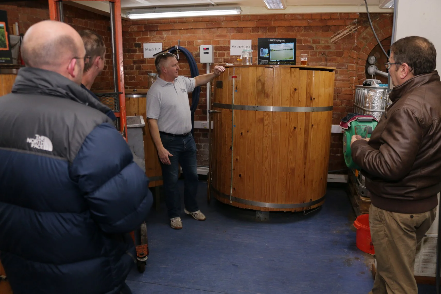 Ray, Director at Towcester Mill, giving a brewery tour over the Mill's Hot Liquor Tank.