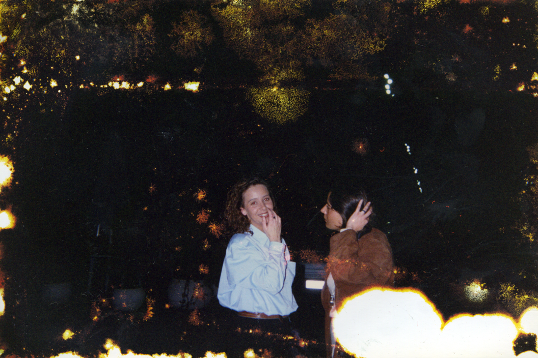 girl-smiling-with-another-girl-in-dark-alot-of-deterior_s.png