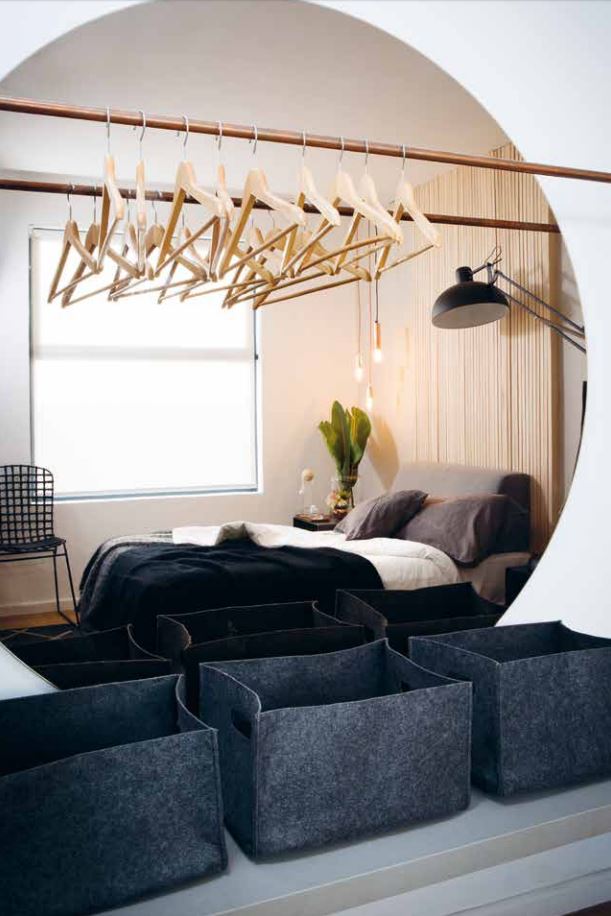 Bronze circle mirror with Caesarstone bench and solid copper exposed closet, photo from VISI 