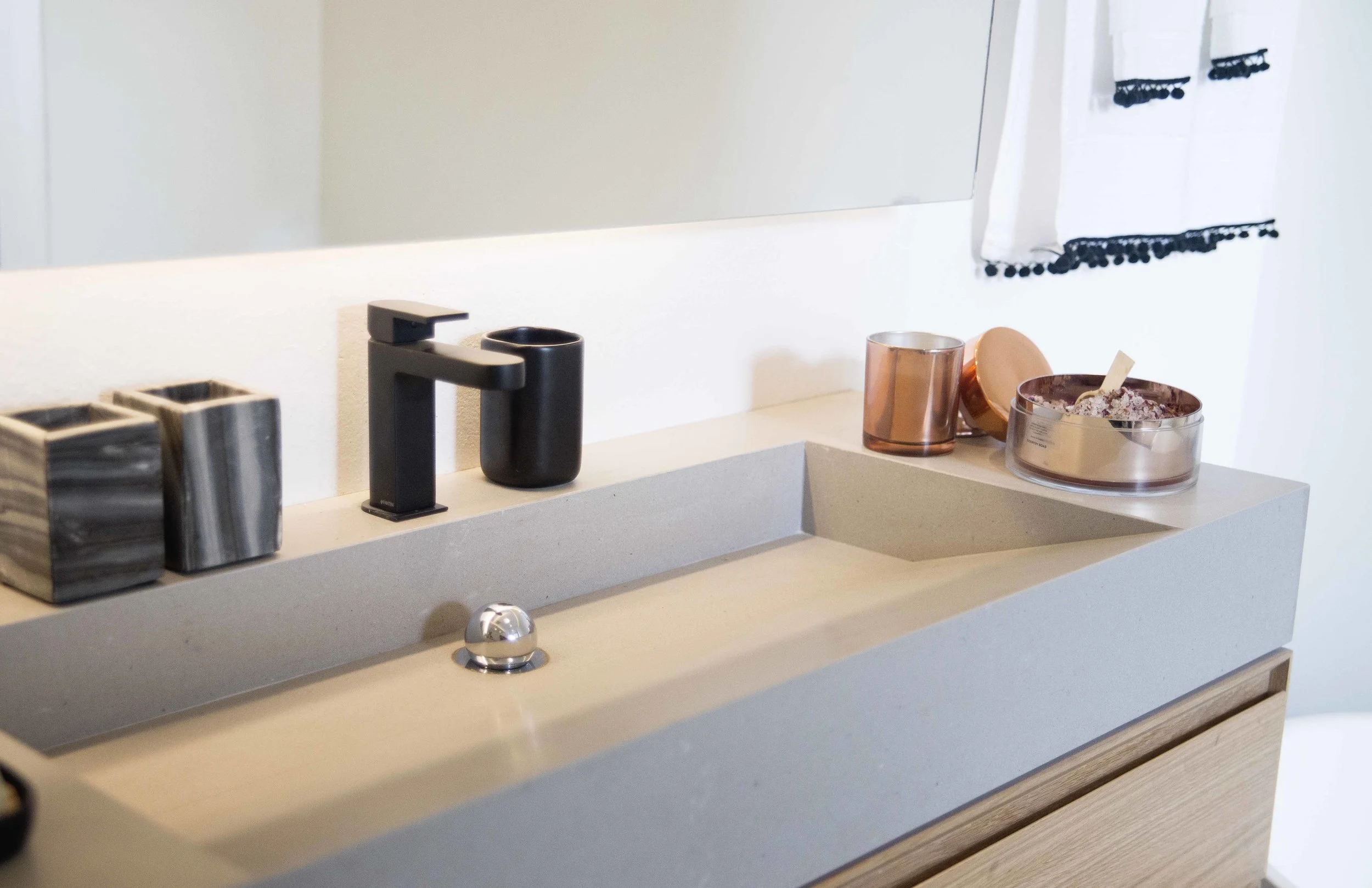 custom designed vanity and Matt black tap with marble and copper finish accesories
