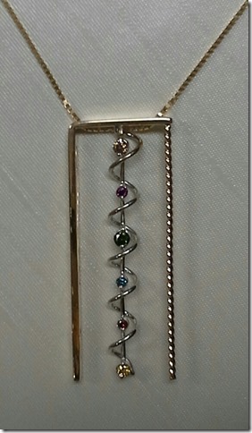 Shannon Smith: Faye’s Diamond Mine 14 karat yellow and white gold pendant with color enhanced multi-colored diamonds in a geometrical twist design.