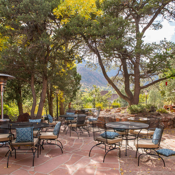 Outdoor eating space with a view of Pikes Peak.