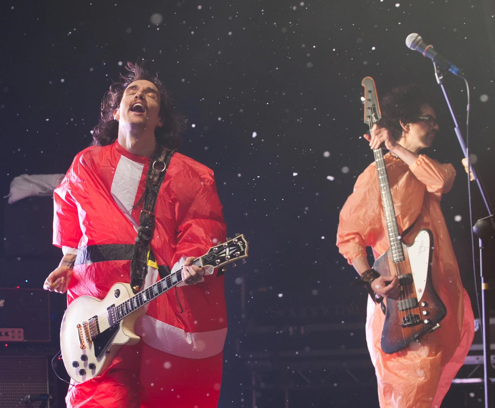 The Darkness perform as snow falls on stage.jpg