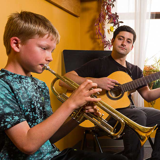 Asheville Music Teacher Sam Irvin in a guitar and trumpet lesson