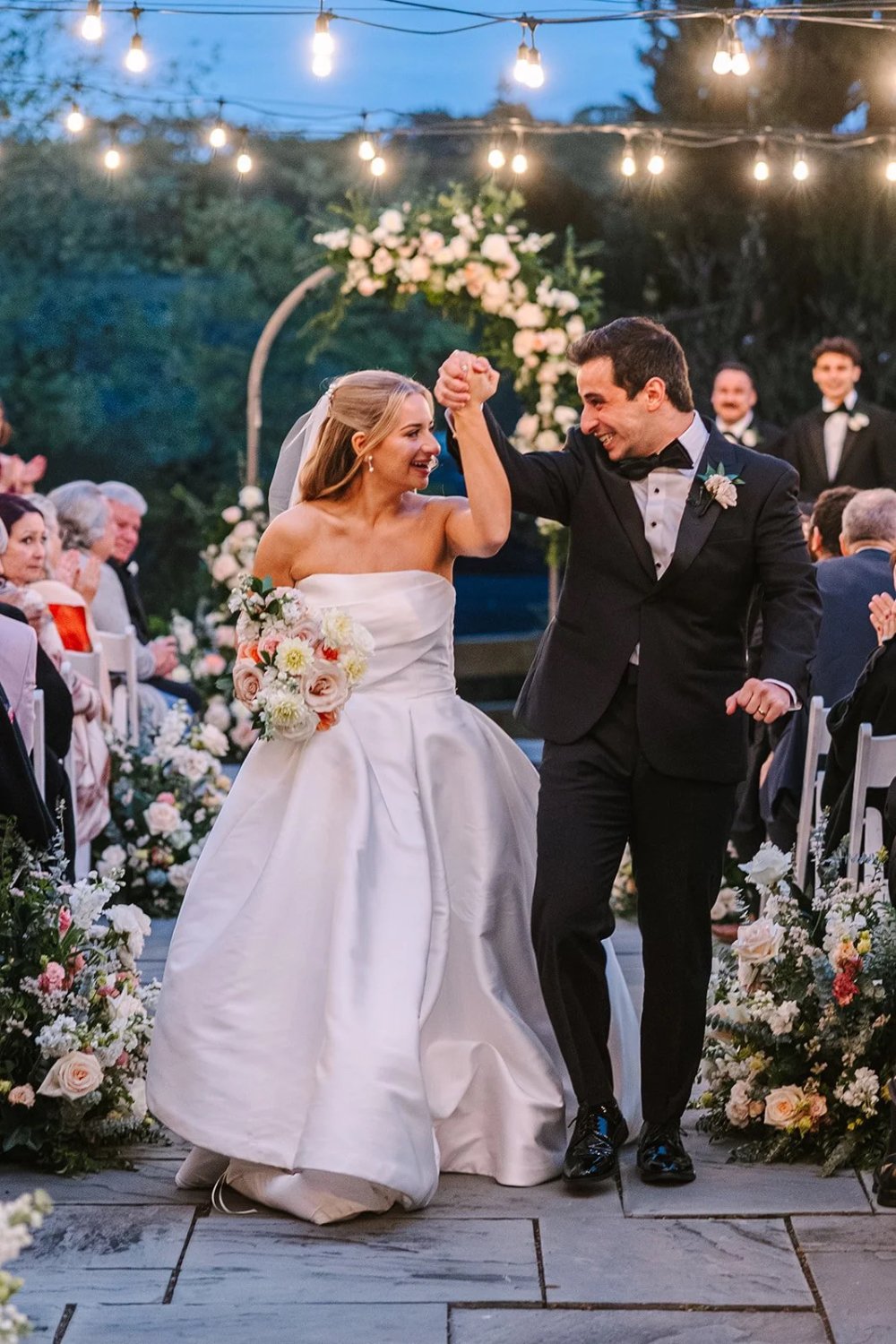 Newlyweds walking back down the aisle celebrating after ceremony