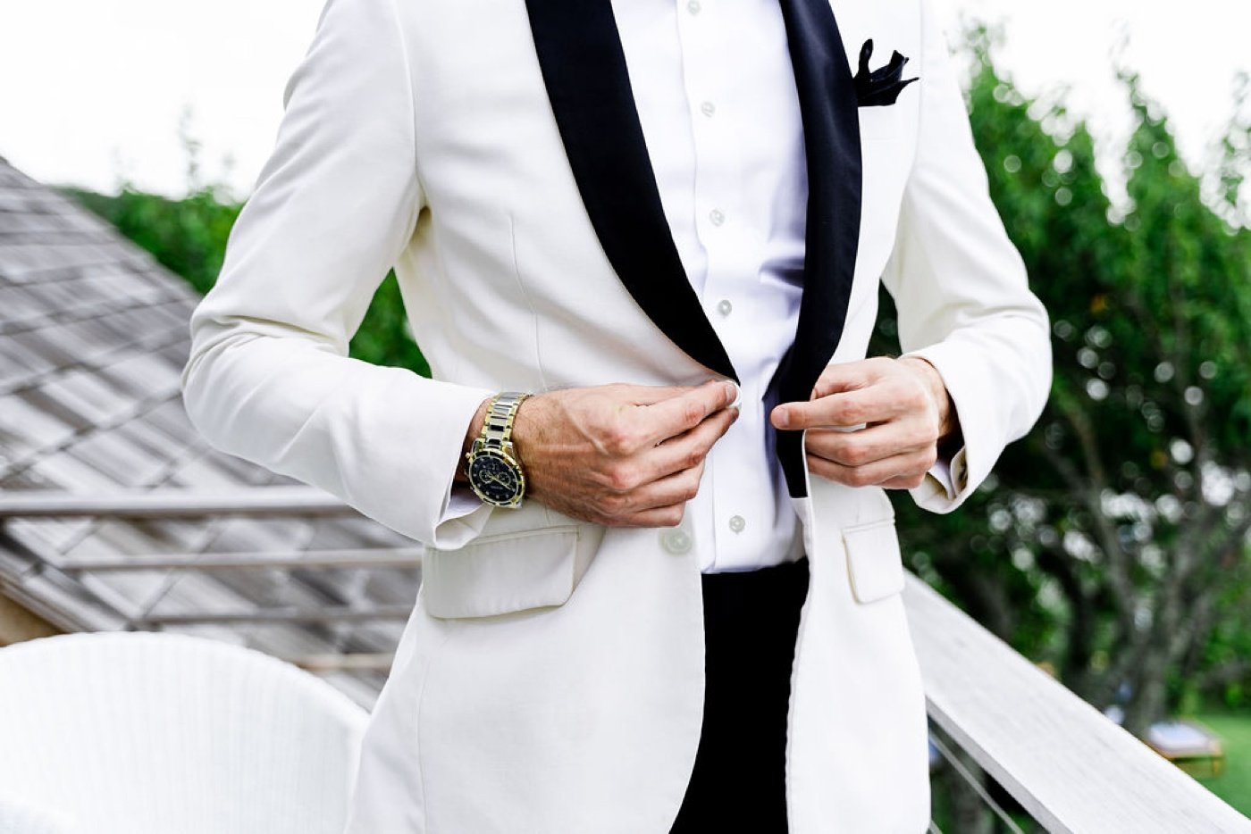 Groom in a white dinner jacket with black lapels by The Black Tux