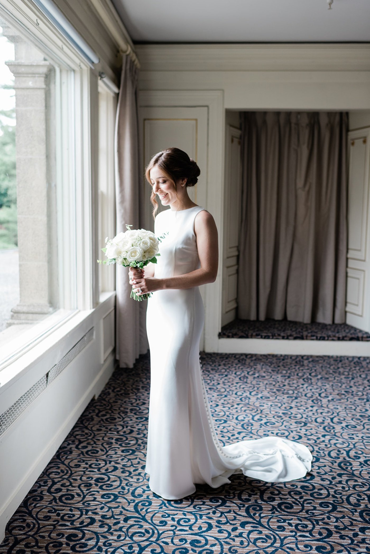 Bride in a custom crepe bridal gown by Katie Fong