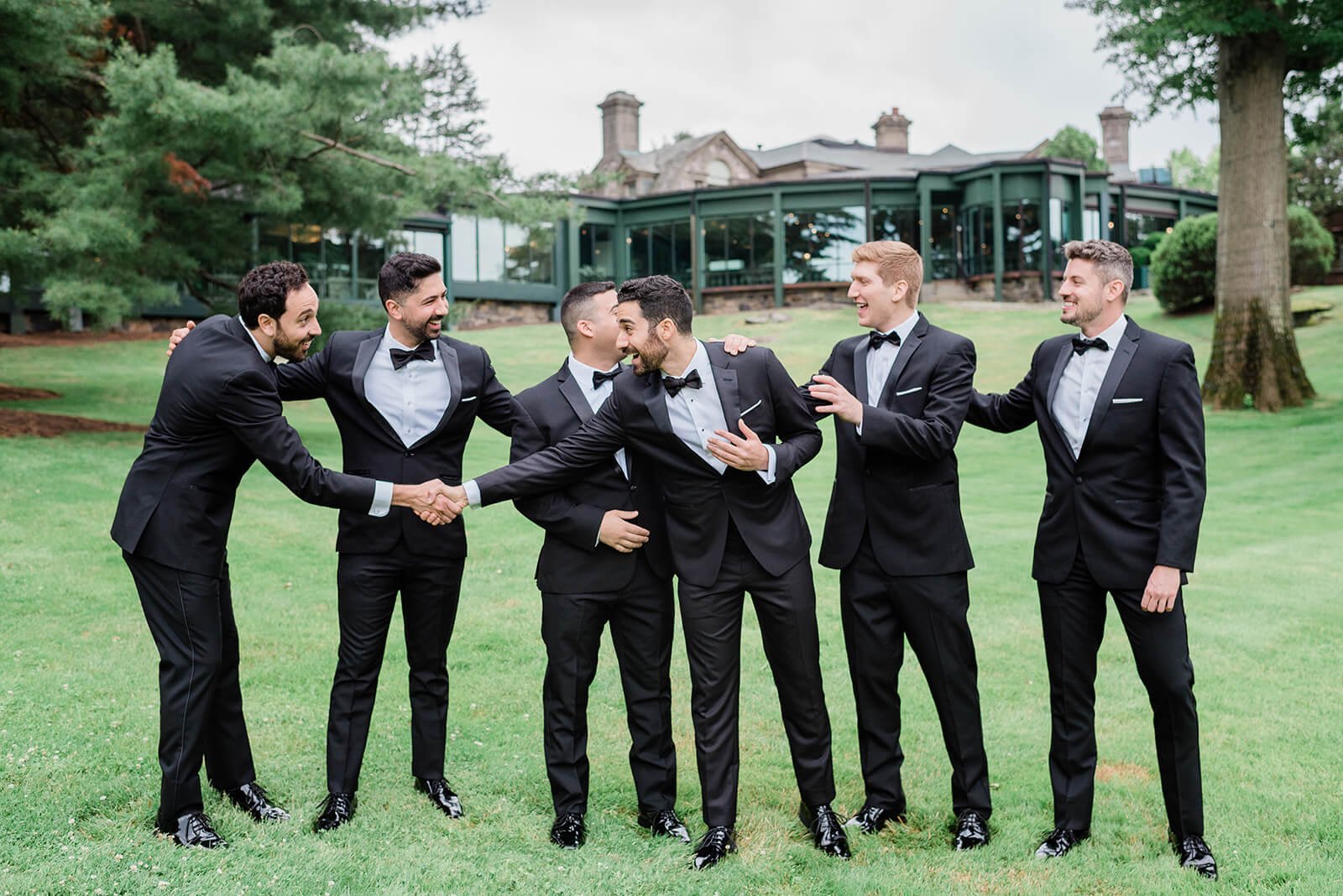 Groom and his groomsmen in black tuxedos
