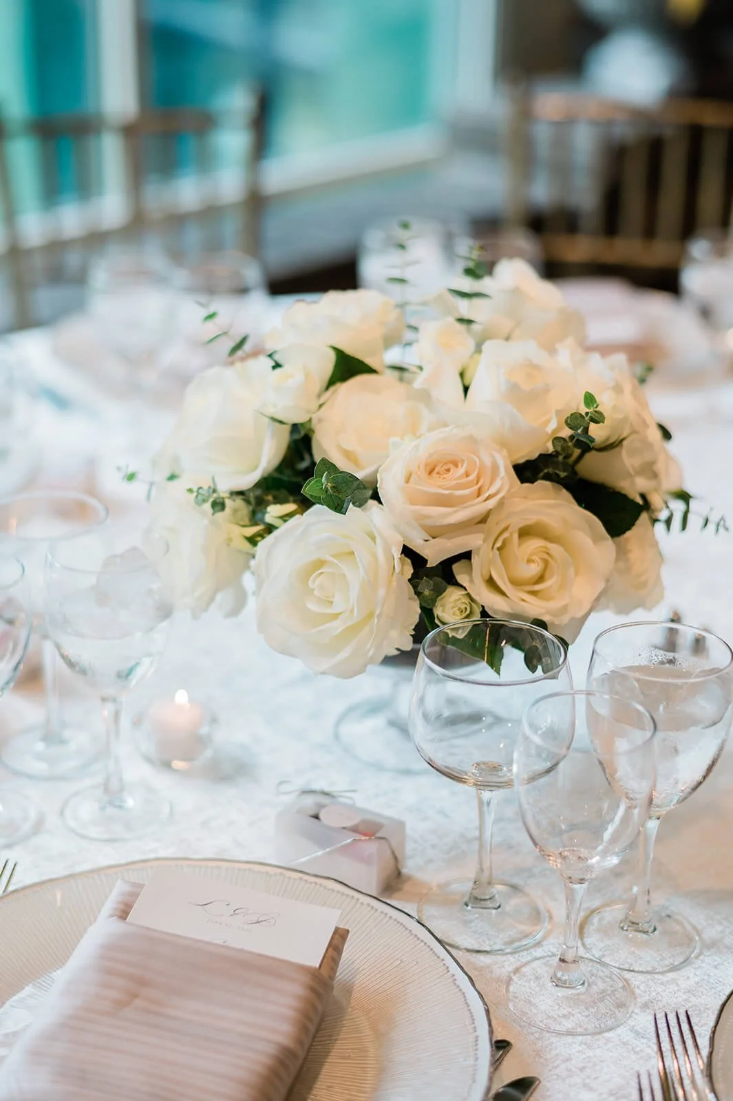 White florals and pastel mauve napkins for a wedding reception