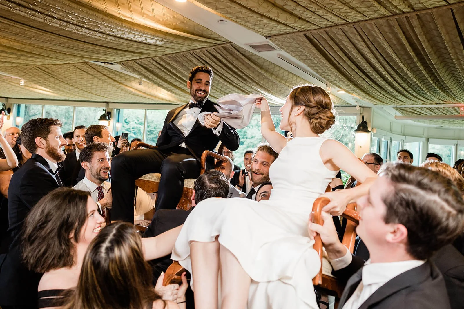 Bride and groom dancing the hora at their wedding reception