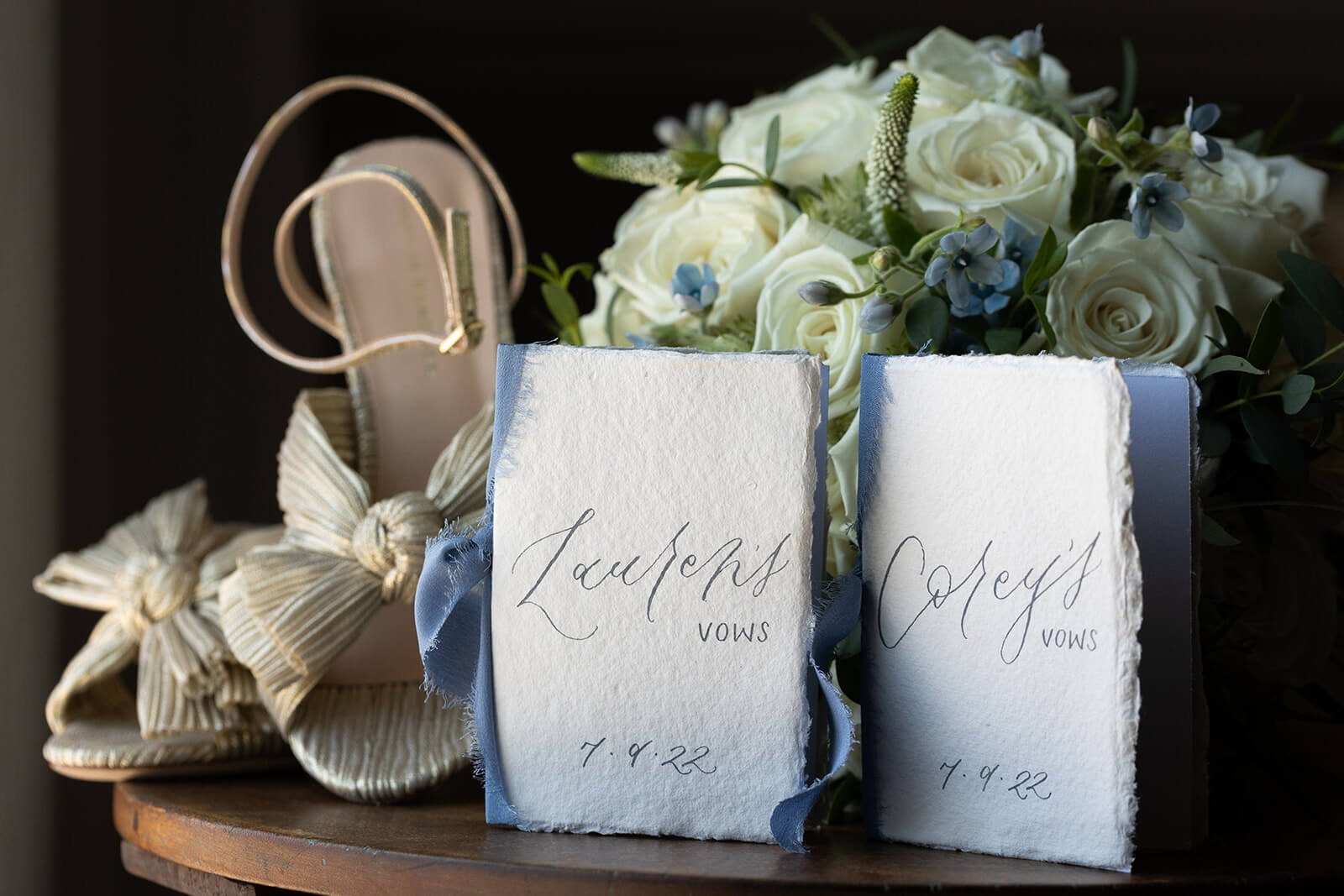 Handmade vow books with blue ribbon and a pair of Loeffler Randall heels