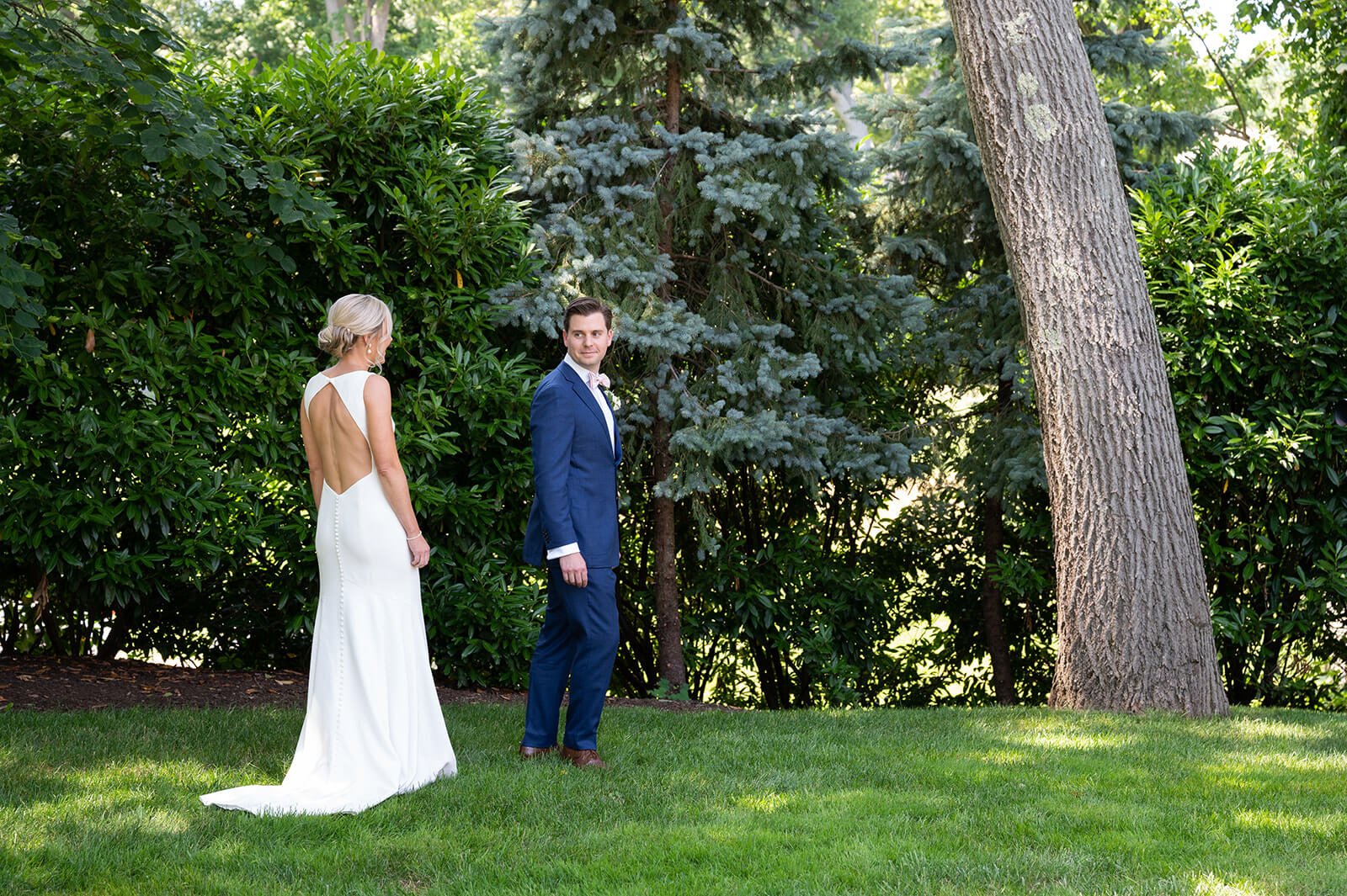 Bride and groom having a first look before their backyard wedding in Long Island, New York
