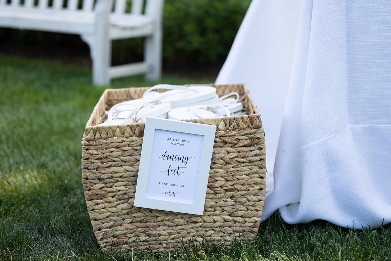 Customized sunglasses and flip-flops for guests at an outdoor wedding