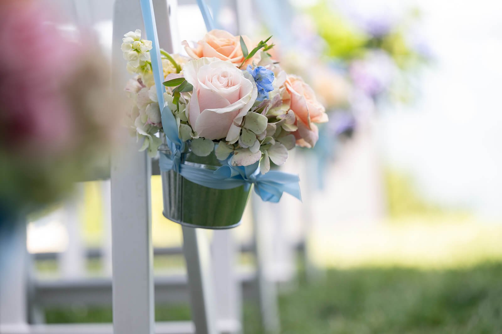 Hanging flowers down a wedding aisle