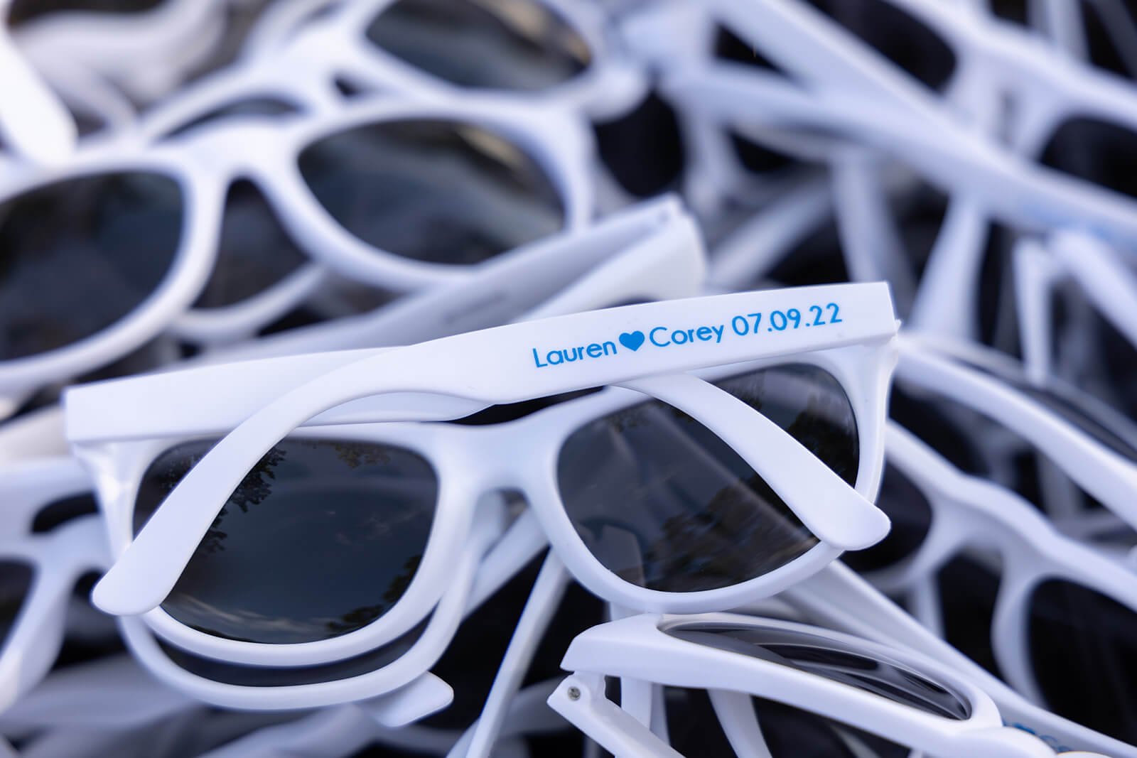 Customized sunglasses and flip-flops for guests at an outdoor wedding