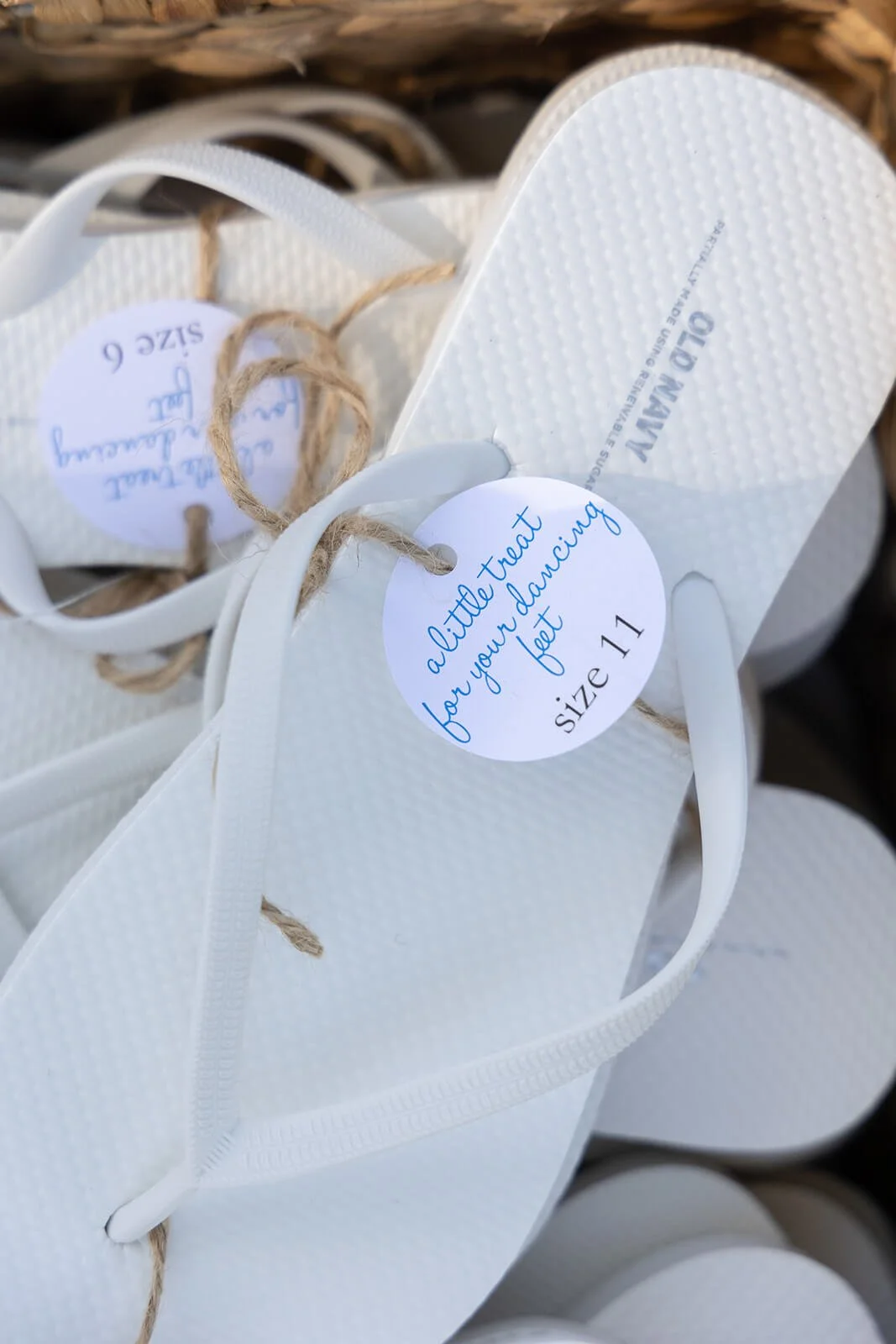 Customized sunglasses and flip-flops for guests at an outdoor wedding