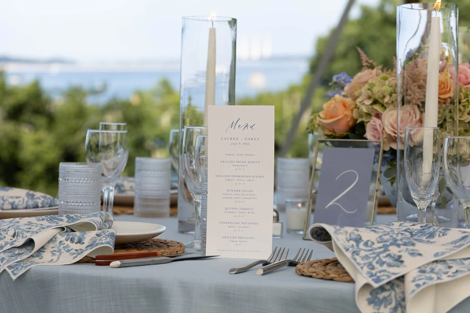 Floral centerpiece with blush roses and green hydrangeas at a summer wedding reception