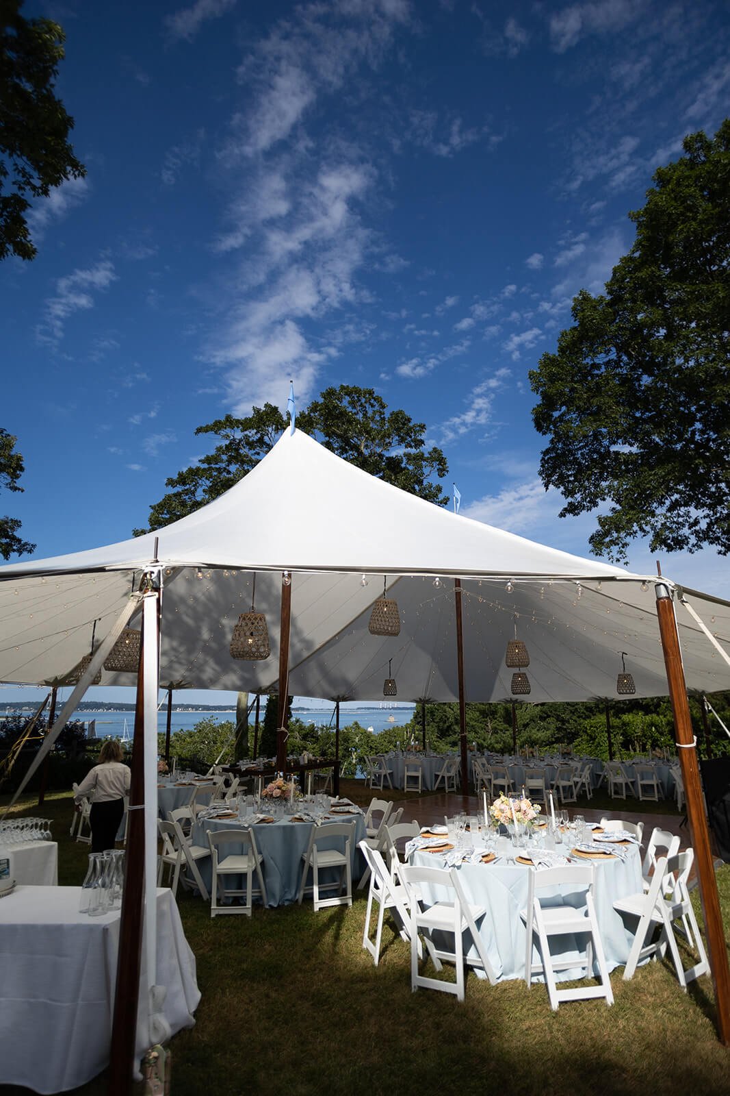 Sailcloth tent with hanging rattan lanterns at a backyard wedding in New York