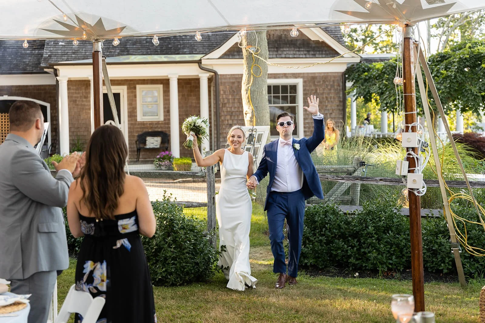 Bride and groom entering their wedding reception