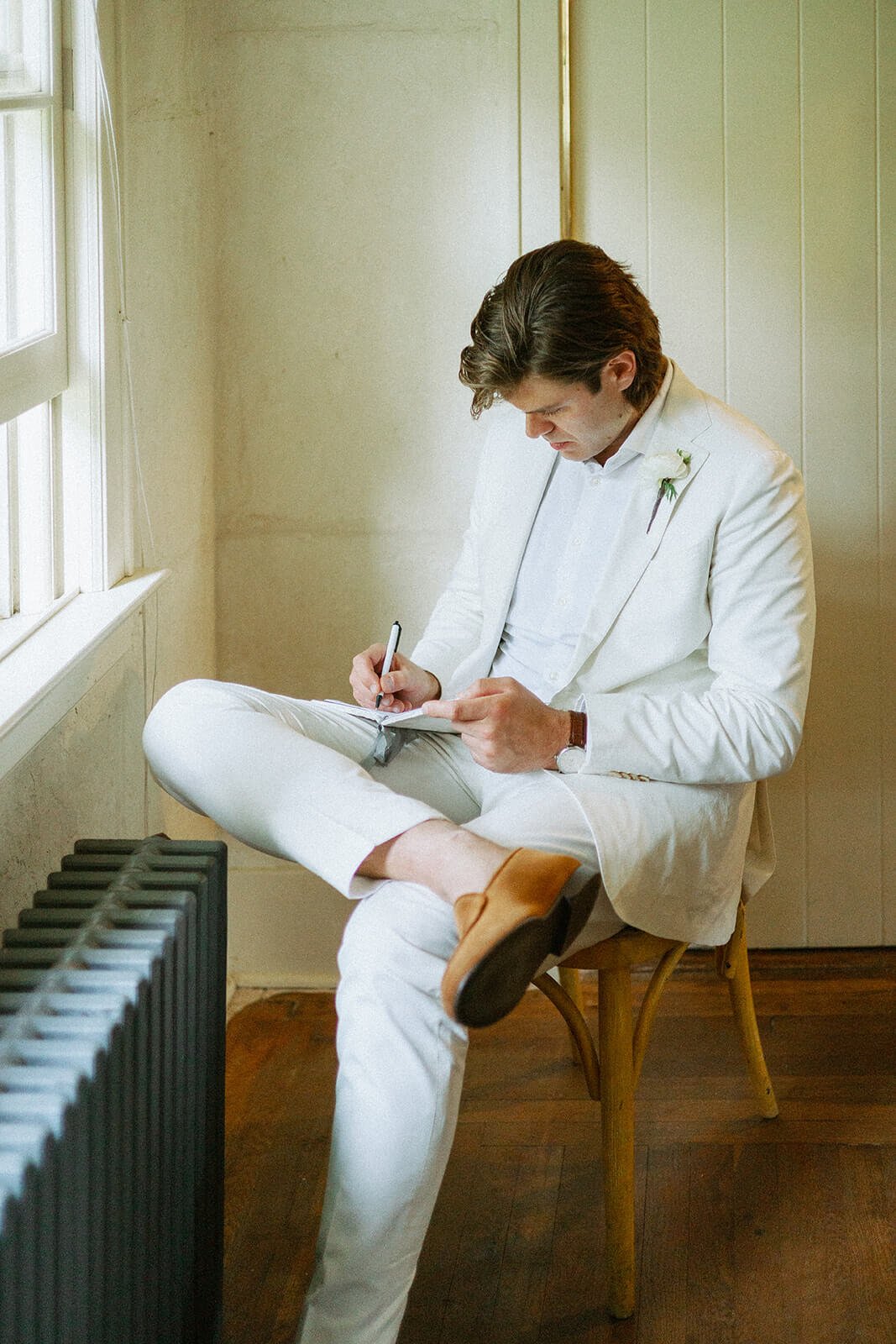 Groom writing his wedding day vows