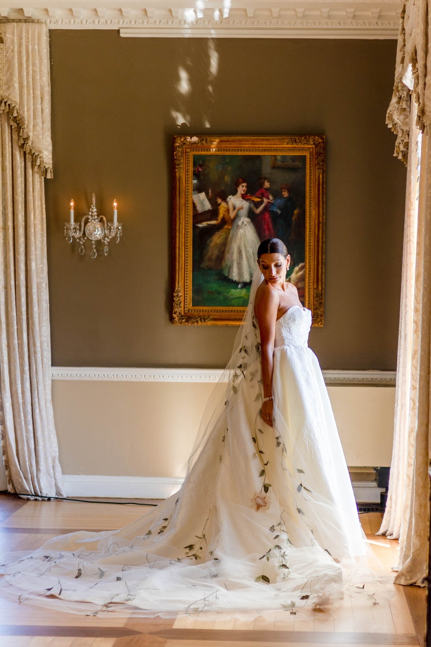 Bride in a textured ballgown with a sweetheart neckline and a veil with leaf appliques