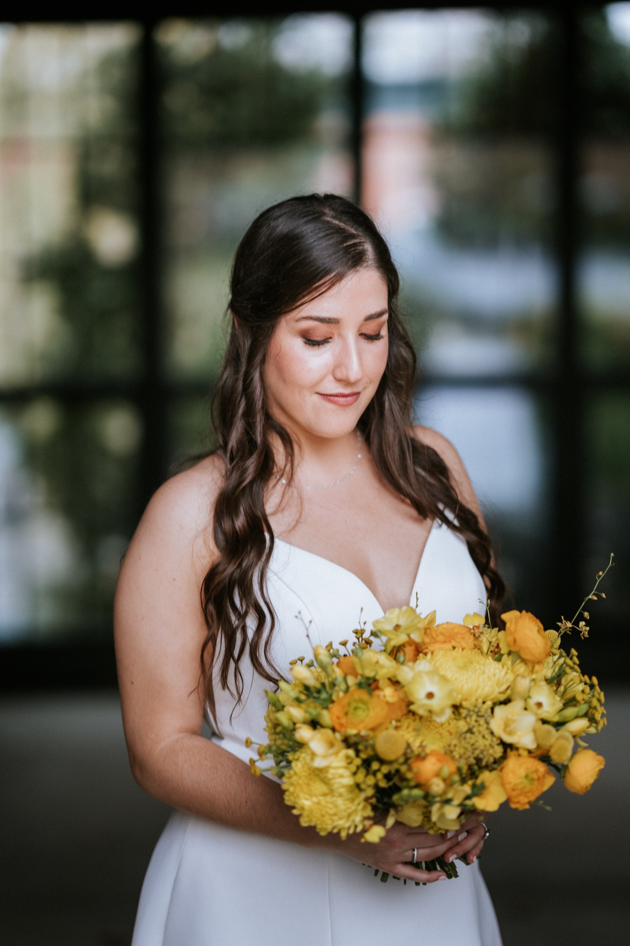 Bride holding an all yellow bridal bouquet by Atha Bold