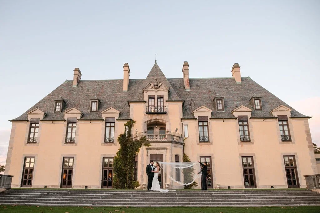 Elegant wedding couple outside a historic estate, showing a luxury option for where to get married in New York.
