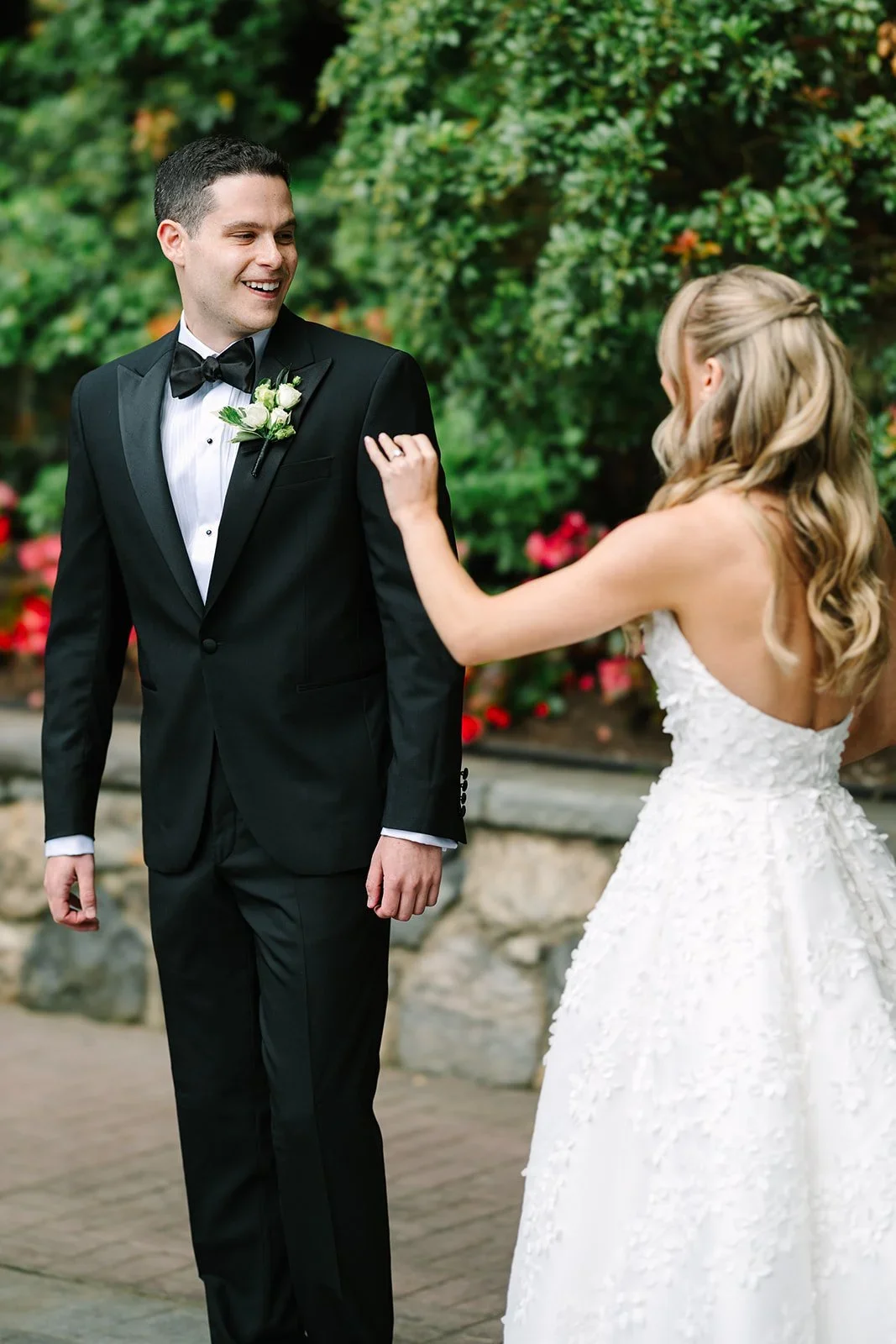 Bride approaching the groom for their first look in a quiet garden during a jewish wedding in New York