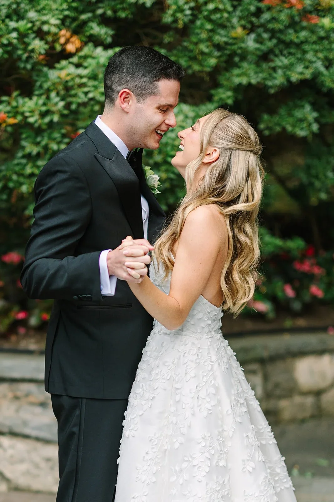 Bride and groom embracing during their first look, sharing a joyful moment before the ceremony