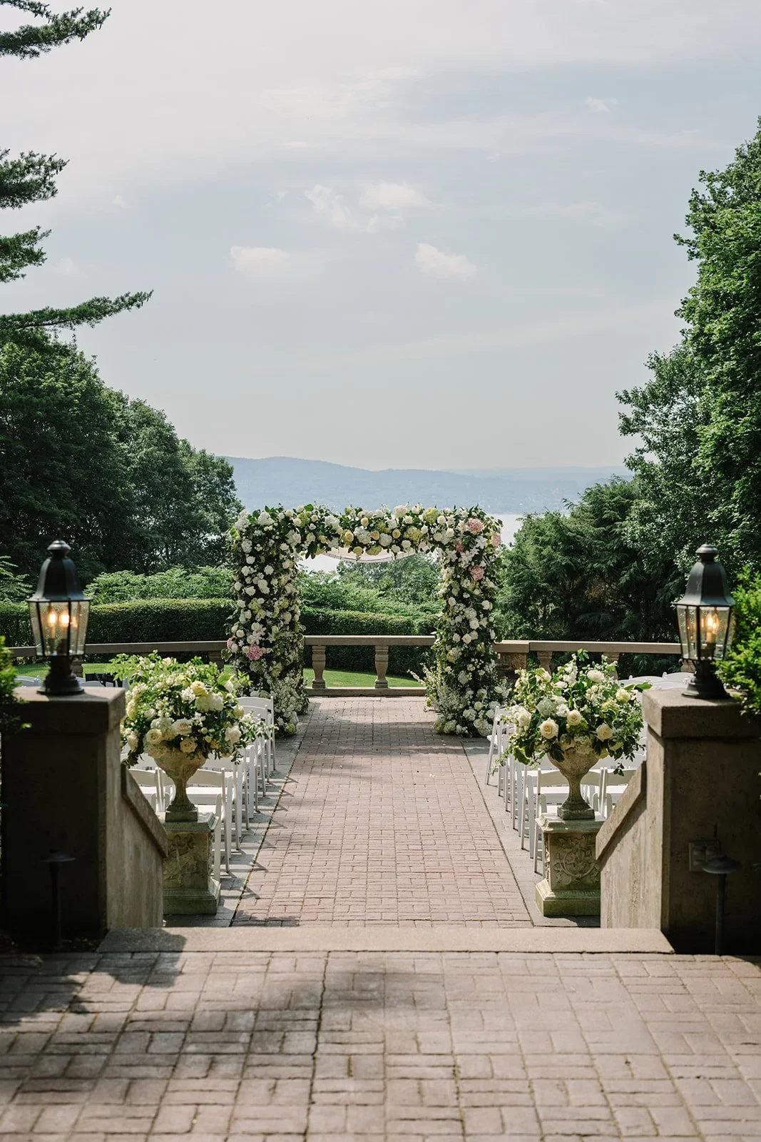 Ceremony setup with floral-lined aisle and chuppah prepared for a jewish wedding in New York