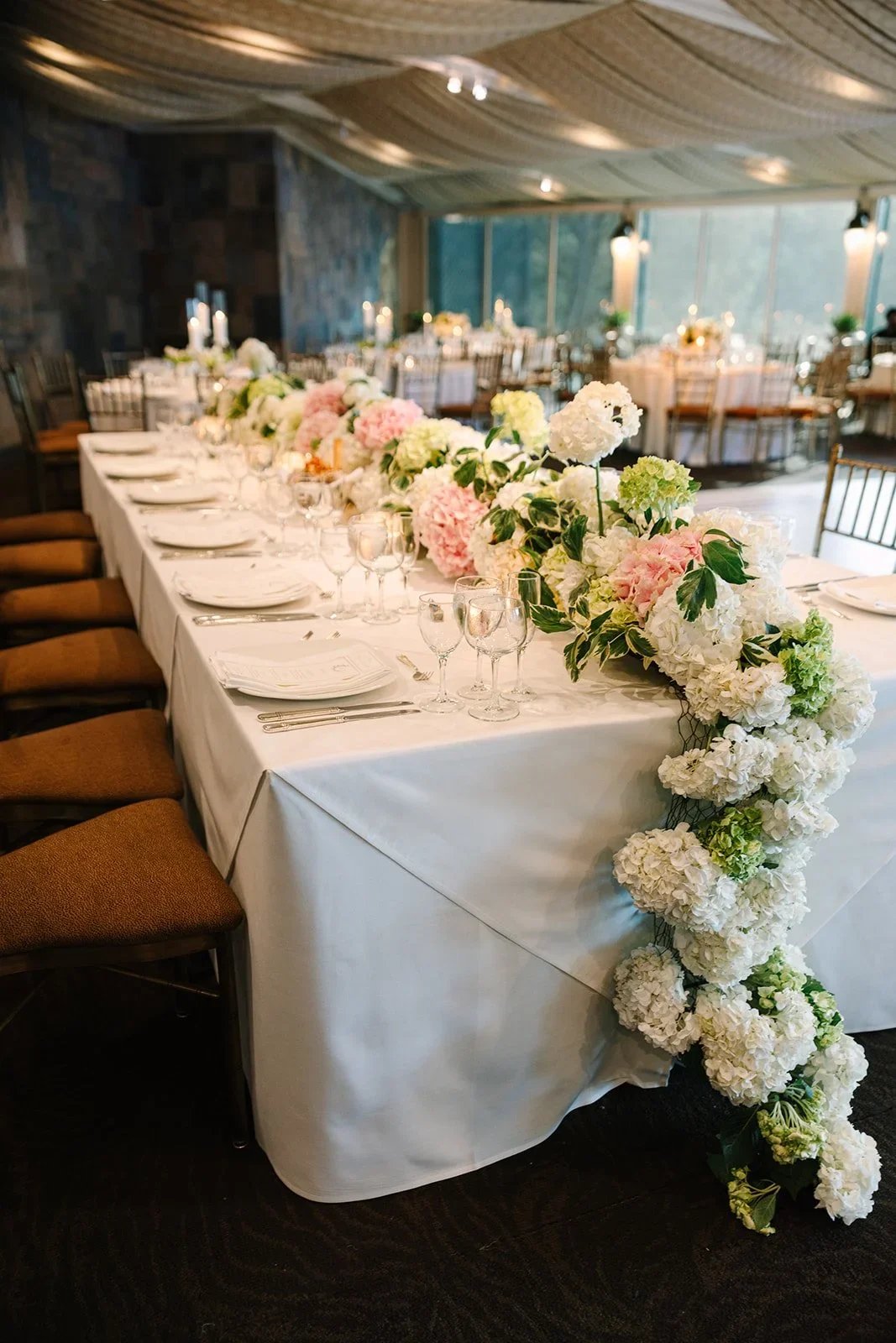 Head table details with lush florals, candles, and elegant place settings at a jewish wedding in New York