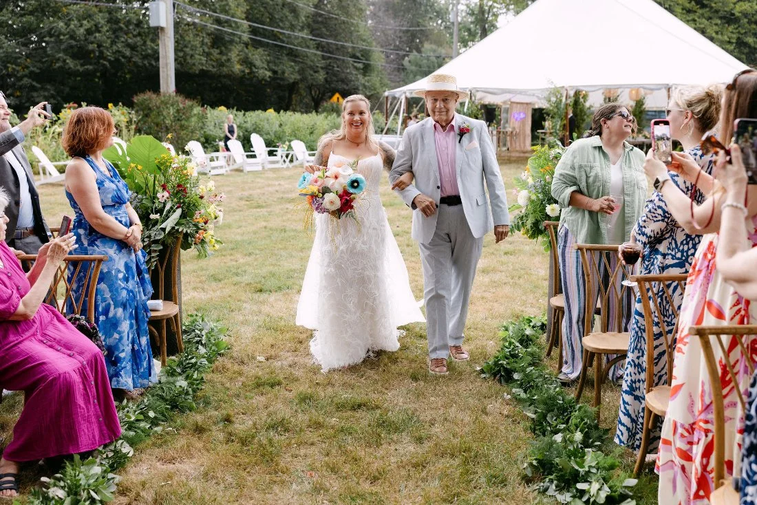 Bride walking down the aisle with her father at backyard outdoor wedding in New York