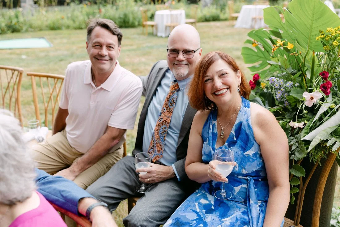 Wedding guests smiling and enjoying cocktails before the ceremony at an outdoor wedding in New York