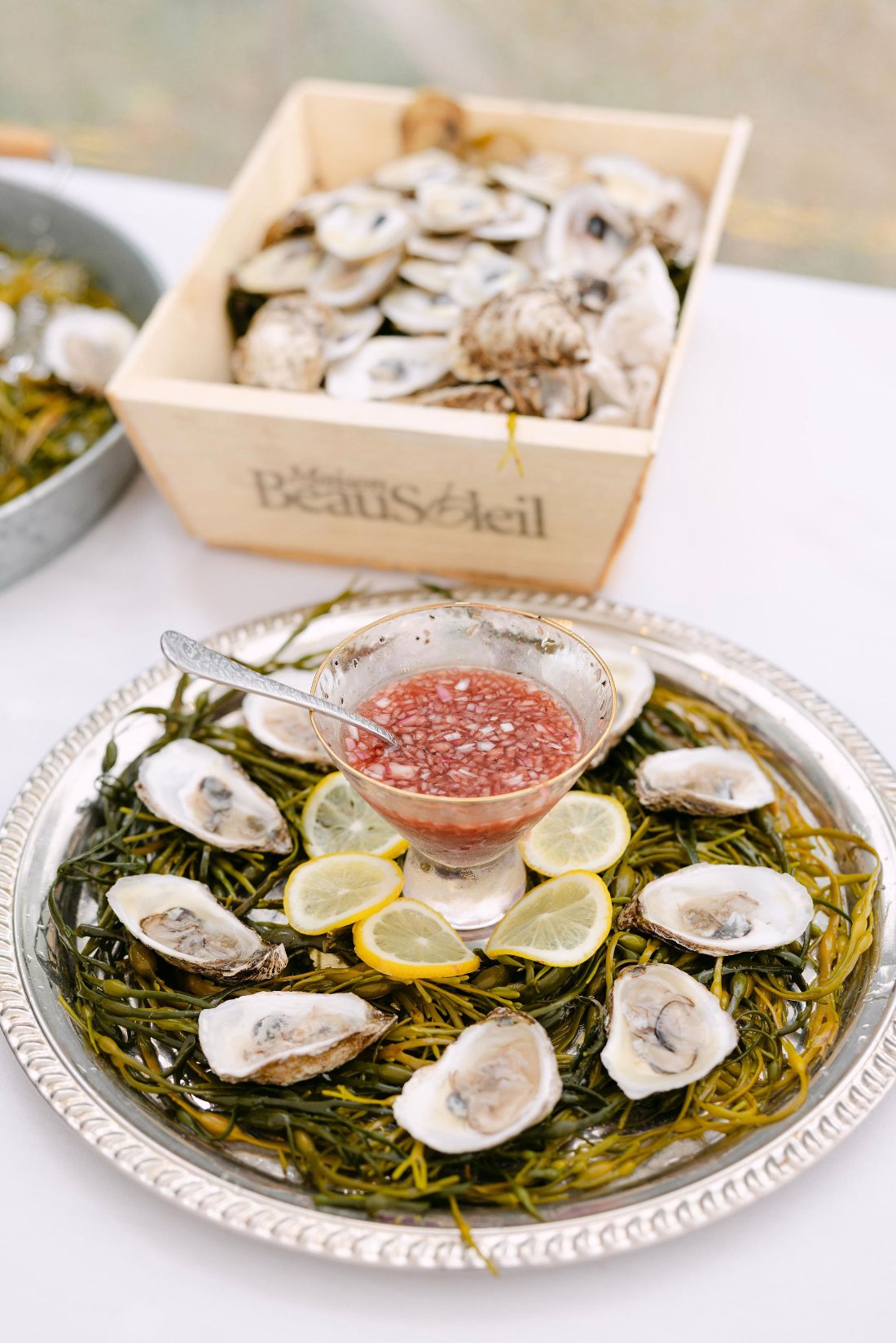 Fresh oyster display with lemons and mignonette at cocktail hour for outdoor wedding in New York